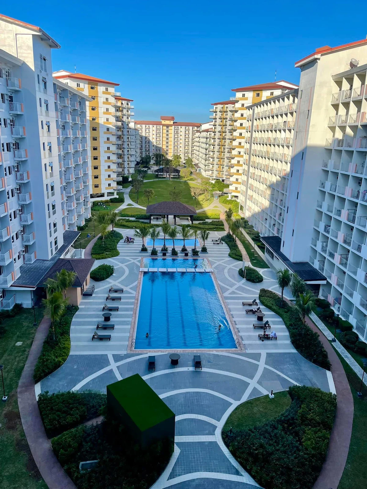 Serene resort-style outdoor swimming pool and tropical courtyard at Field Residences