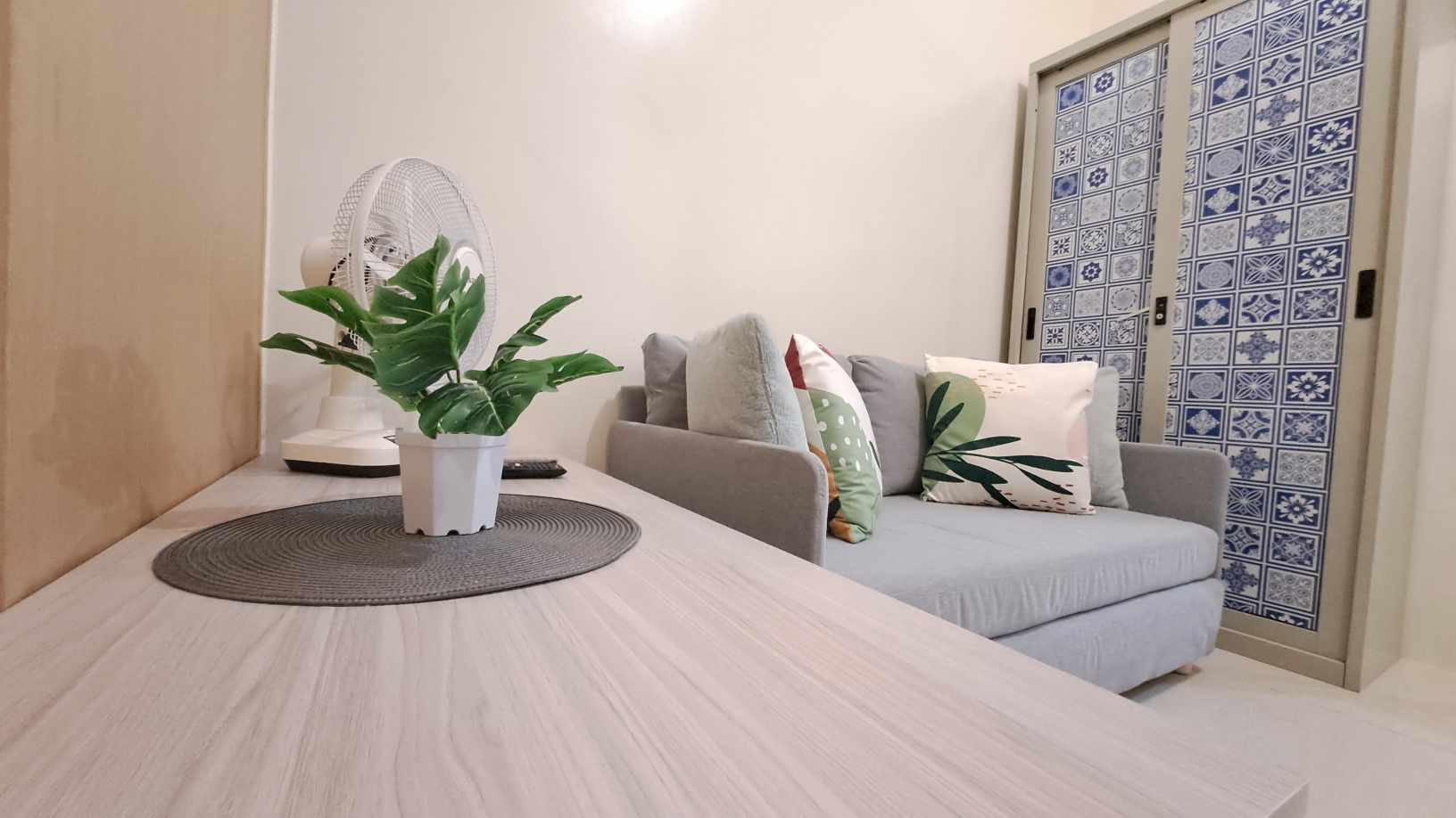 Comfortable queen-size sofa bed prepared with clean pillows and linen